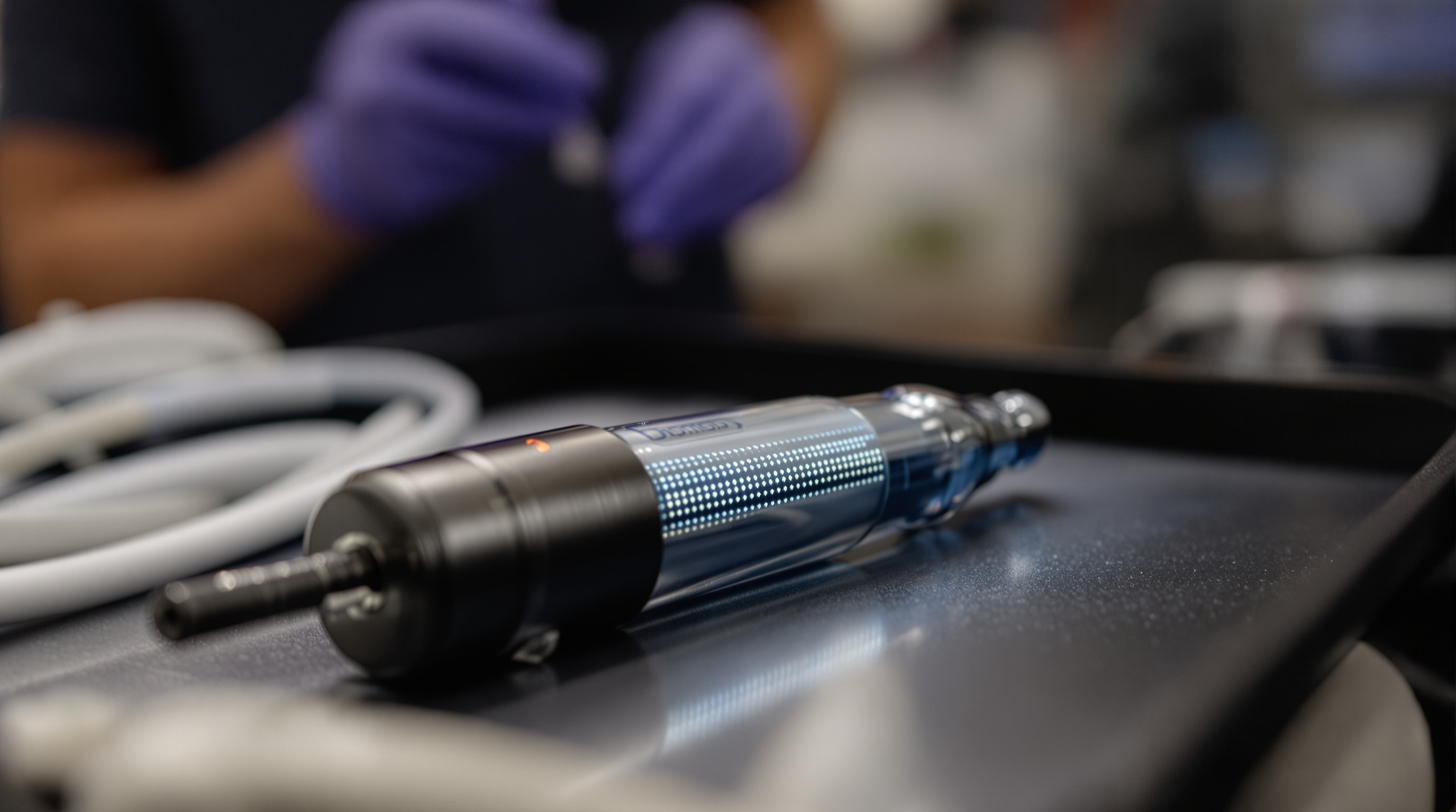 A dermatologist guiding a microneedling pen across a reclined patient's cheek in a bright modern clinic room